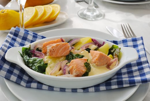 Baked salmon with potatoes and spinach cream sauce