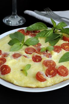 Caprese omelet with mozzarella, tomato and basil