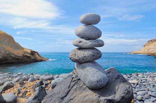 Pile of pebbles in the balance on the seacoast