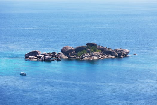 stony island in the Andaman Sea and the yacht, the top view. Thailand