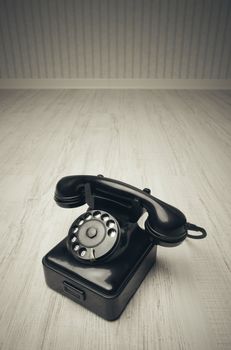 Old-fashioned phone on a wooden floor