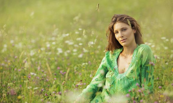 Beautiful woman enjoying nature in the flowers field