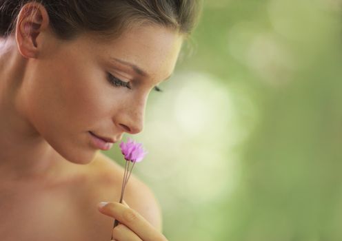 Portrait of Fresh and Beautiful woman with flower. Soft focus