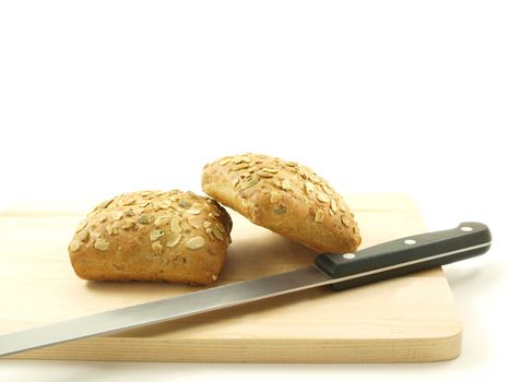 Bread with seeds isolated on a wooden board