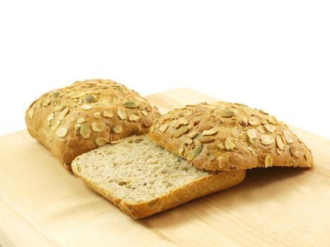 Bread with seeds isolated on a wooden board