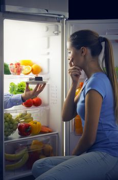 Woman contemplating if she should ruin her diet