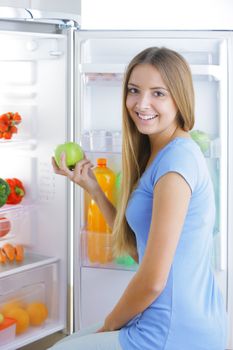 Young woman takes an apple