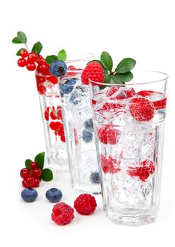 juice / cocktail with currant, blueberry and ice, isolated on white background