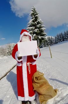 Santa Claus, Father Christmas holding blank sign