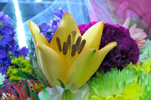 A lily in a bouquet of flowers
