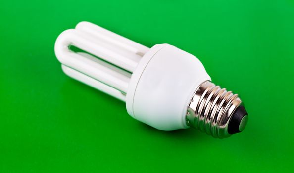 Energy saver bulb over green background