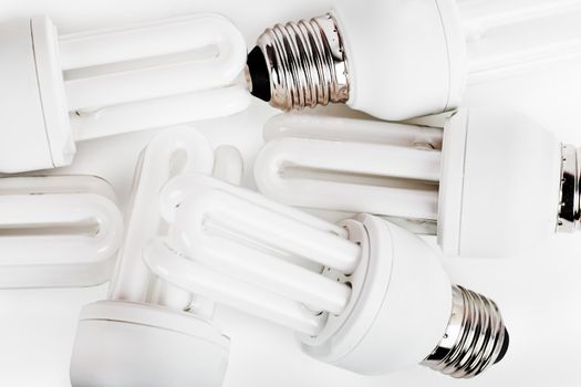 Heap of energy saver bulbs over white background