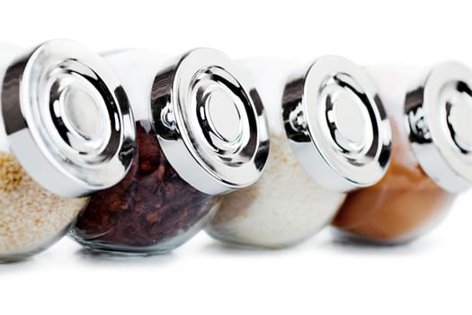 Closeup view of small glass jars with spices