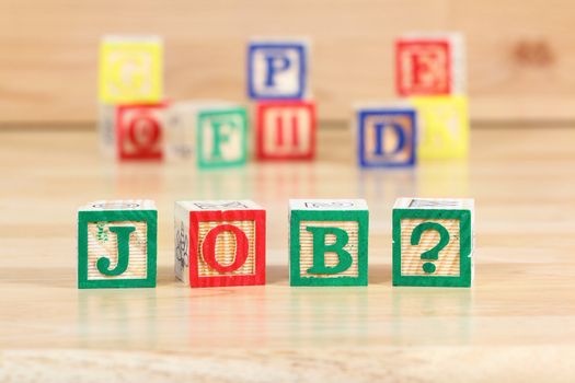 Wooden blocks with letters. Children educational toy concept - thinking about job in kindergarden.