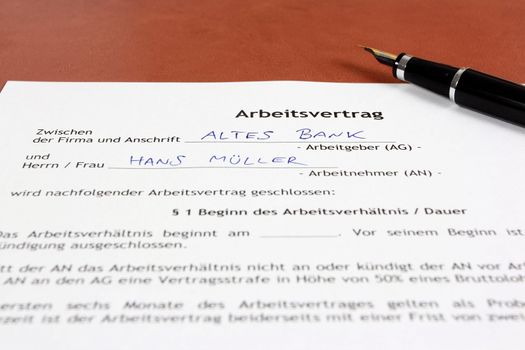 Business objects - full time employment contract in German language ready to sign with ink pen. Germany career. Fictitious generic company name and person name.