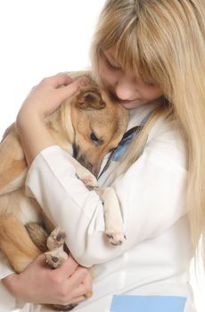 kind woman veterinarian, hugging a puppy