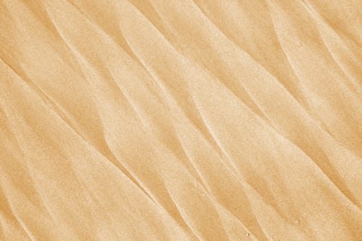 Sand waves - beautiful beach background. Abstract orange texture.