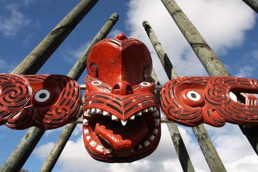 Maori red carving - face carved in the wood. Rotorua, New Zealand.