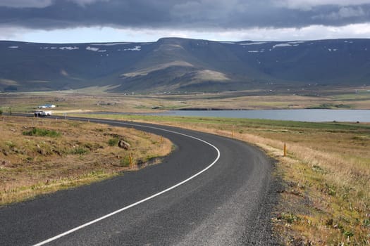 Road bend next to Hvalfjordur fiord in Iceland. Summer landscape.