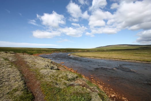 Hiking trail along the river Botnsa, near Glymur waterfall. High plains in Iceland. Summer landscape.