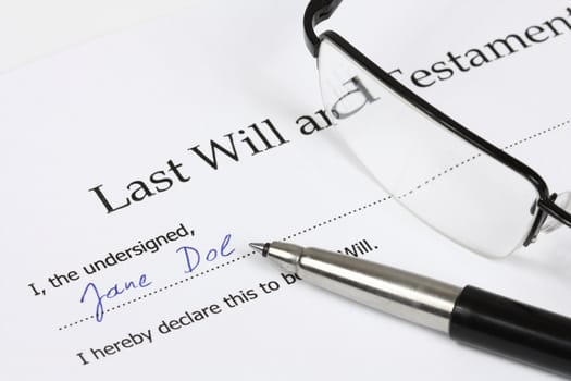 Last Will and Testament with a fictional name and signature. Glasses, document, pen.