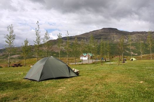 Campground tents in Geysir - famous tourist area in Iceland. Summer camping.