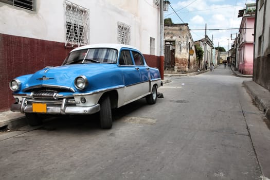 Camaguey, Cuba - old town listed on UNESCO World Heritage List. Vintage American car.