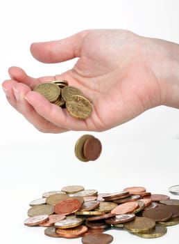 some euro coins falling from a human hand