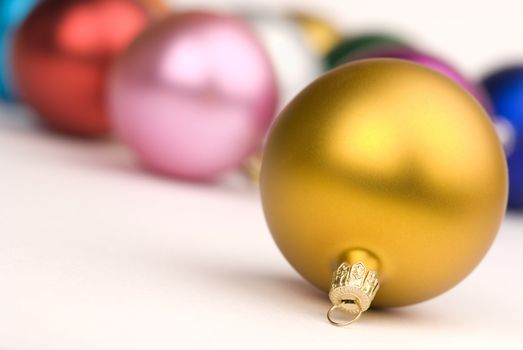 christmas decorations on the white background, focus point on metal part on nearest ball