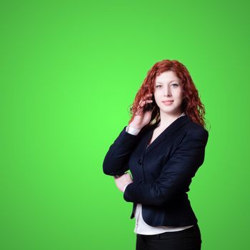 long red hair businesswoman on the phone on green background