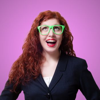 smiling red long hair businesswoman on pink background