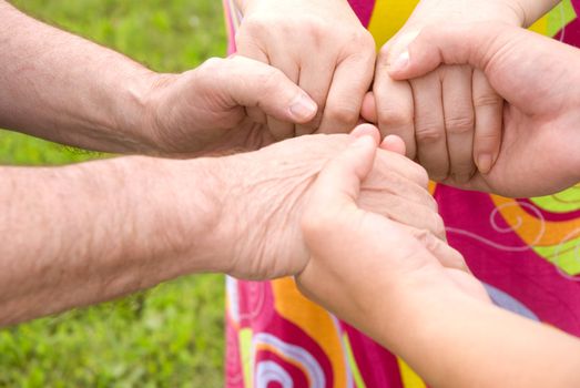 family concept (focus point on hands of the woman)