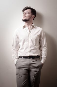 stylish modern guy with white shirt on gray background