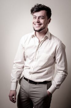 stylish modern guy with white shirt on gray background
