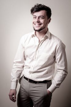 stylish modern guy with white shirt on gray background