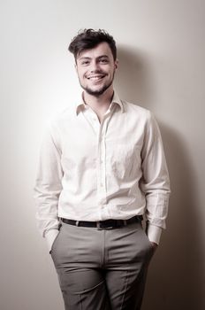 stylish modern guy with white shirt on gray background