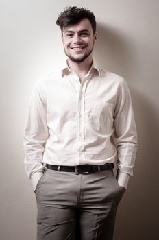 stylish modern guy with white shirt on gray background