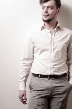 stylish modern guy with white shirt on gray background