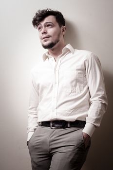 stylish modern guy with white shirt on gray background