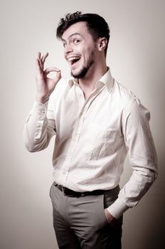 stylish modern guy with white shirt on gray background