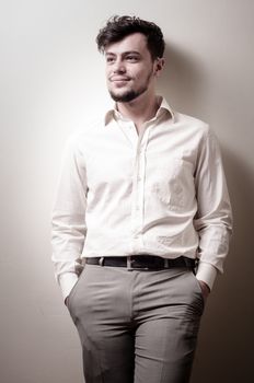 stylish modern guy with white shirt on gray background