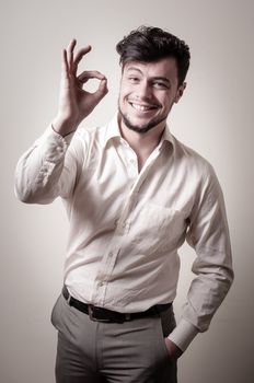 stylish modern guy with white shirt on gray background