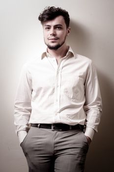 stylish modern guy with white shirt on gray background