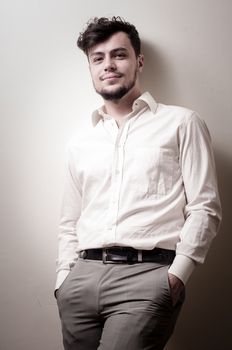 stylish modern guy with white shirt on gray background