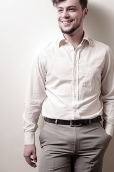 stylish modern guy with white shirt on gray background