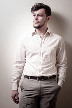 stylish modern guy with white shirt on gray background