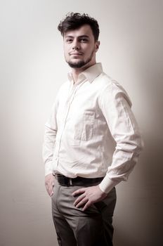 stylish modern guy with white shirt on gray background