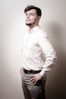 stylish modern guy with white shirt on gray background