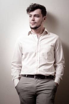 stylish modern guy with white shirt on gray background