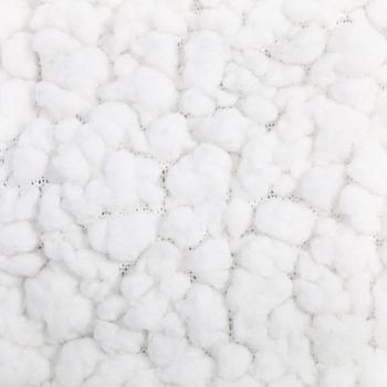 Background texture and pattern of a soft fluffy white textile with balls of white fibres resembling clouds